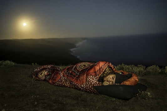 Aboriginal woman sleeping in an the rockhole dreaming sleeping bag